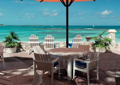 Terrace of a restaurant with yello sun shades on a beautiful caribbean beach